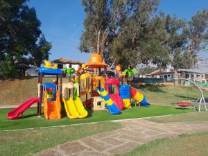 a park with a playground with a slide at Iguaque Lodge in Villa de Leyva