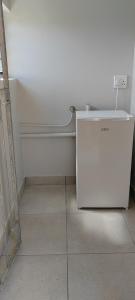 a white refrigerator in the corner of a room at Pleasant Hill in Gqeberha