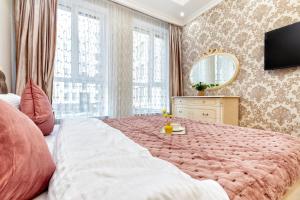 a bedroom with a large bed and a mirror at Апартаменты возле ЭКСПО in Astana