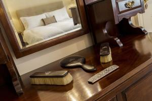 a wooden dresser with a mirror and a bed at College Hill House in Slane