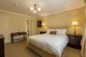 a bedroom with a large white bed and two night stands at College Hill House in Slane