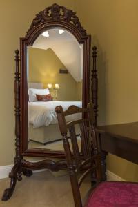 a large mirror in a room with a bed at College Hill House in Slane