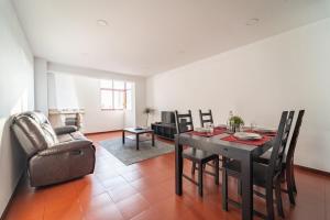 een woonkamer met een eettafel en stoelen bij Feliciano Ramos 1 - T4 familiar perto do centro da cidade - Braga in Braga