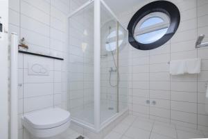 a bathroom with a shower with a toilet and a mirror at Villa 3M in Tučepi +30 photos