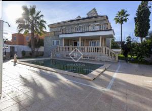 a house with a swimming pool in front of a house at Villa Esperanza in La Eliana