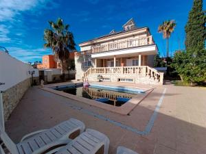 a house with a pool in front of a building at Villa Esperanza in La Eliana