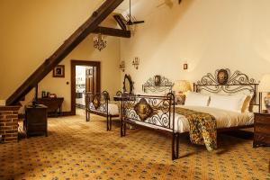 a bedroom with two beds and a staircase at Lainston House in Winchester +37 photos