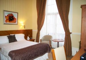 a hotel room with a bed and a window at The Bulkeley Hotel in Beaumaris