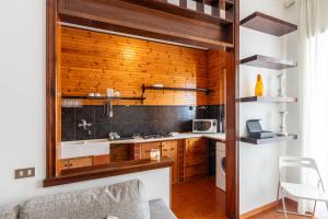 a kitchen with wood paneling and a counter in a room at Pane&Pomodoro Apartment in Bari