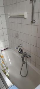 a bath tub with a faucet in a bathroom at Ferienwohnung Marienkäfer in Wulkow