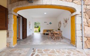a room with a table and chairs in a building at Angel Village in San Teodoro