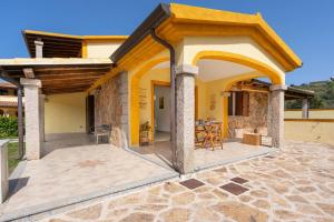 an outdoor patio with a table and chairs at Angel Village in San Teodoro