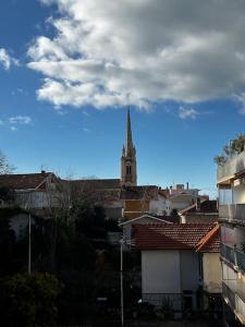 a view of a church with a steeple in a city at Appartement centre Arcachon in Arcachon