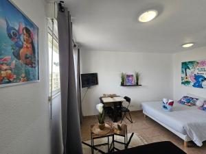 a room with a bed and a table in it at A312 Appartement Disneyland Paris Europe in Montévrain