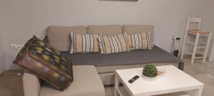a living room with a couch with pillows and a table at Hermes green in Artemida +37 photos