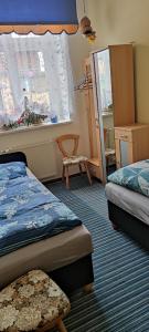 a bedroom with two beds and a window at Ferienwohnung Marienkäfer in Wulkow