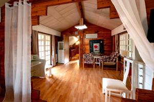 a living room with wood floors and a room with a ceiling at Wooden Stories in Isthmia