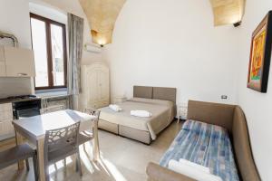 a room with a bed and a table and a couch at Dimore casalesalento in Nardò +99 photos