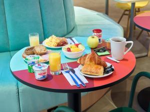 a table with a tray of breakfast food on it at B&B HOTEL Paris 17 Batignolles in Paris