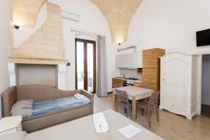 a living room with a couch and a table at Dimore casalesalento in Nardò
