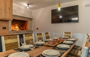 a dining room with a table and a fireplace at Cdi706 in Murvica