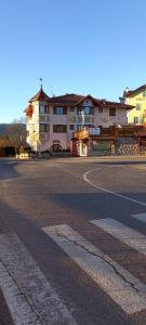 an empty street in front of a large building at Hotel Giusy in Malosco
