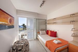 a bedroom with a bed and a large window at Protaras Elaia Luxury Seafront Villa in Protaras +58 photos