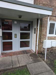 a front door of a brick house with at Above us only sky in Kirkby