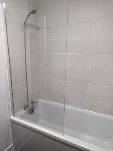 a shower in a bathroom with a glass door at Above us only sky in Kirkby