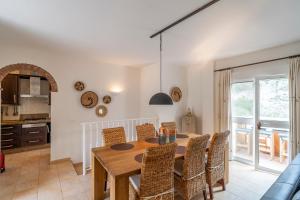 een keuken en eetkamer met een houten tafel en stoelen bij Siempre Verde in Alcaucín