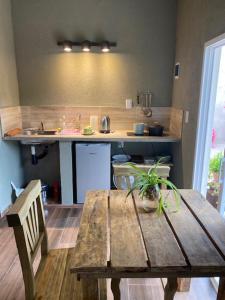a kitchen with a wooden table and a counter top at lo de lucio in Almafuerte