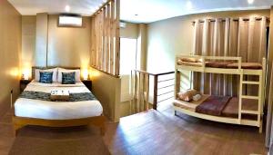 a bedroom with two bunk beds and a staircase at Southseas Beach Resort and Dive Center in Santander