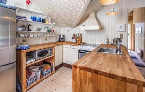 a kitchen with a sink and a refrigerator at Three-Bedroom Holiday Home In Skalskor in Skælskør