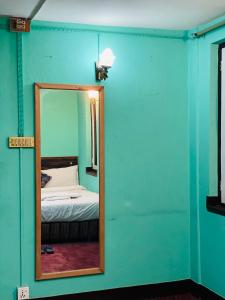 a mirror in a room with a bed in it at Heranya Hostel in Kathmandu