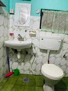 a bathroom with a toilet and a sink at Heranya Hostel in Kathmandu