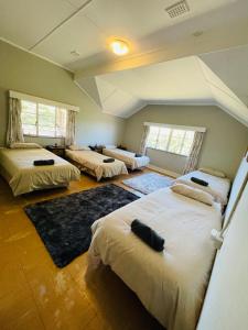 a room with three beds in a room at Sugar Farm House in Pietermaritzburg