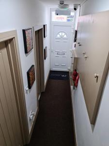 a hallway in an rv with a white door at SureBillionaire Home Deluxe Queen Studio in London