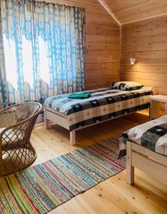 a room with two beds and a window in a cabin at Fishing and holiday village Merikoivula in Uusikaupunki