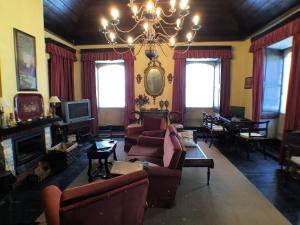 a living room with couches and a chandelier at Casa Da Ponte Arcos De Valdevez in Arcos de Valdevez