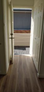 an empty room with an open door with a window at Great Three Bedroom House Opposite Hospital & University in Frankston