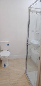 a bathroom with a toilet and a sink at Great Three Bedroom House Opposite Hospital & University in Frankston