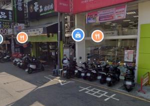 a group of motorcycles parked in front of a building at 逢甲馨宿 in Hsia-shih-pi
