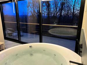 a bath tub in front of a window with a tennis court at Chado Belgrade in Belgrade