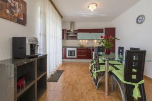 a kitchen with a table and chairs in a room at RASTOVCAN P in Povile