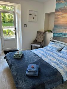 a bedroom with a bed with towels on it at Lily Bank Room in Stonehaven