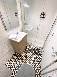 a bathroom with a sink and a shower at Delightful City Centre Studio Clarendon Apartment - Grand Central House in Gibraltar