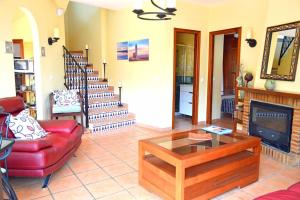 a living room with a red couch and a fireplace at Casita Tranquila in Almería