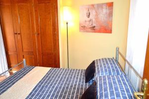 a bedroom with a bed with a dog standing on it at Casita Tranquila in Almería +19 photos