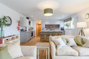 a living room with a couch and a kitchen at Ladybird in Boston