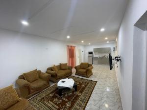 a living room with couches and a table at DIaR MAHER in Al Maqārisah